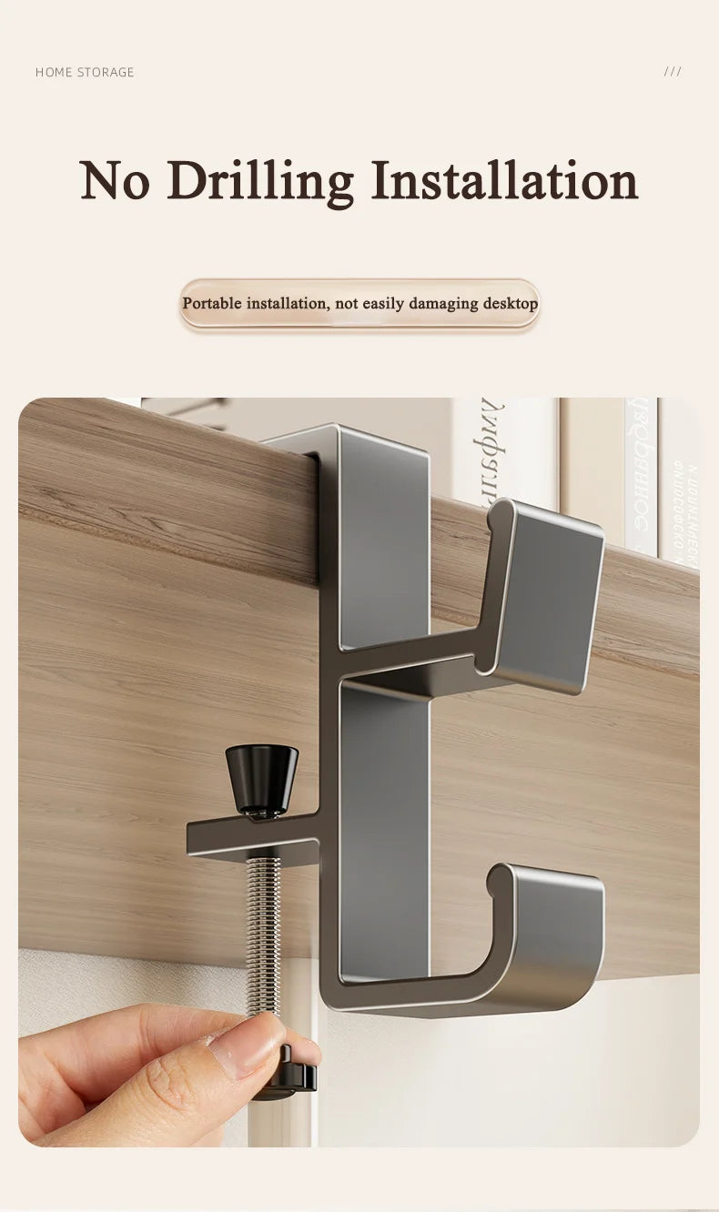 A close-up of a metal adjustable desk bag hook being installed into a wooden surface.