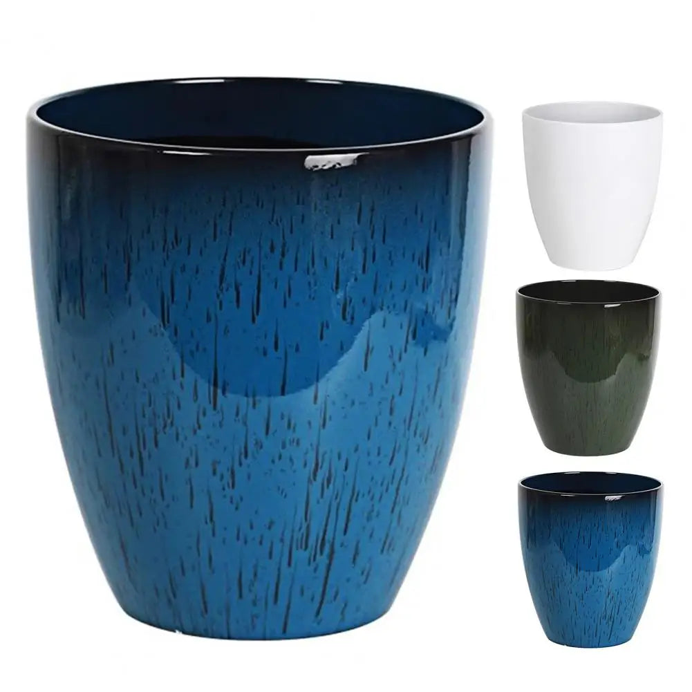 A large, textured blue resin planter with a matching small cup and a separate saucer.