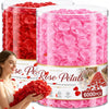 A close-up of red and pink rose petals in glass jars for event decoration