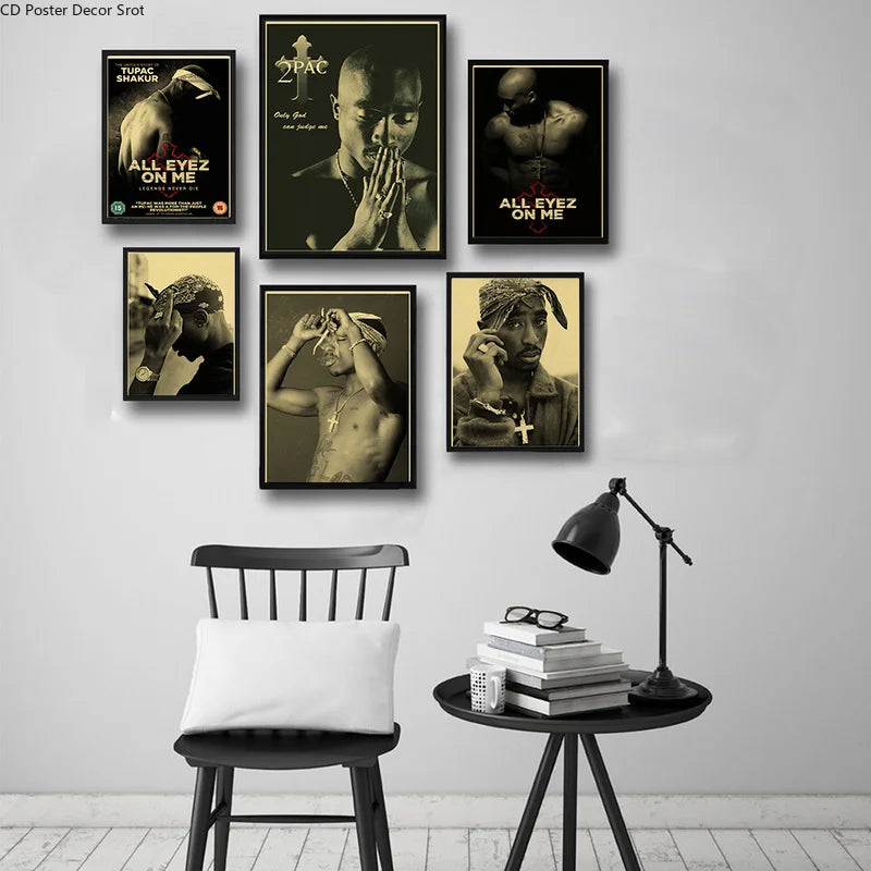 A gallery wall display featuring several black and white posters of Tupac Shakur.