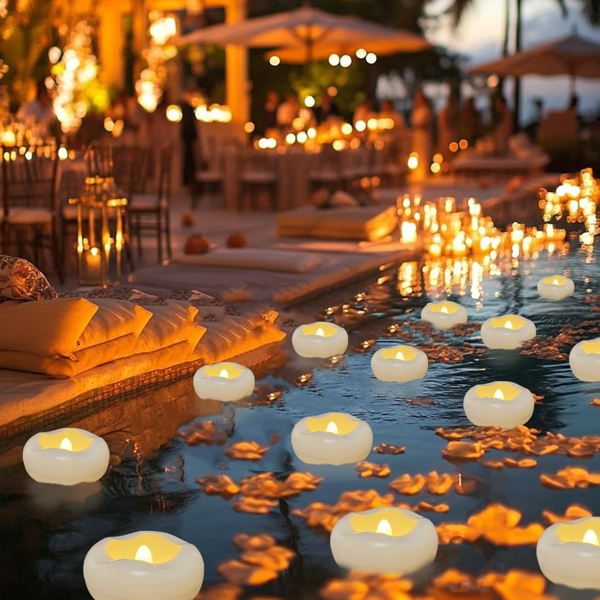 Floating candles illuminate dark water with warm light and golden reflections in an outdoor setting.