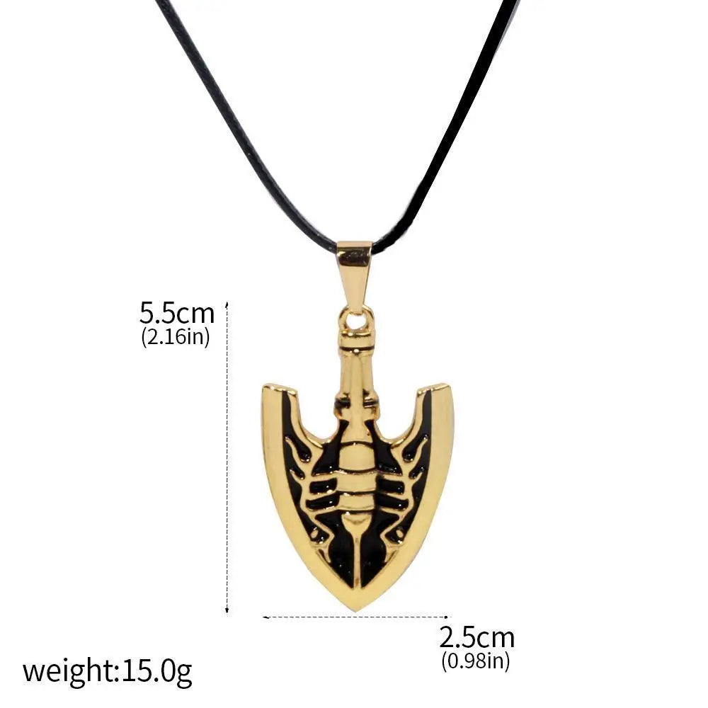 Gold metal arrow keychain featuring a stylized JoJo's Bizarre Adventure motif on a black cord.