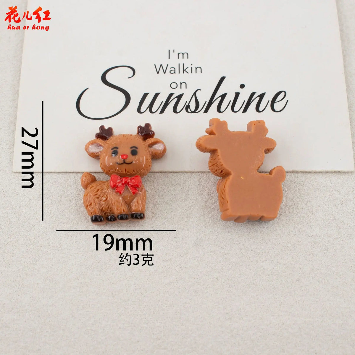 Two small, brown resin figurines shaped like deer or reindeer are displayed on a white background.