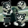 A collection of black and white ghost cat plush toys featuring a hood and a knife.