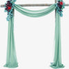 A wedding arch decorated with teal chiffon draping fabric panels and floral accents.
