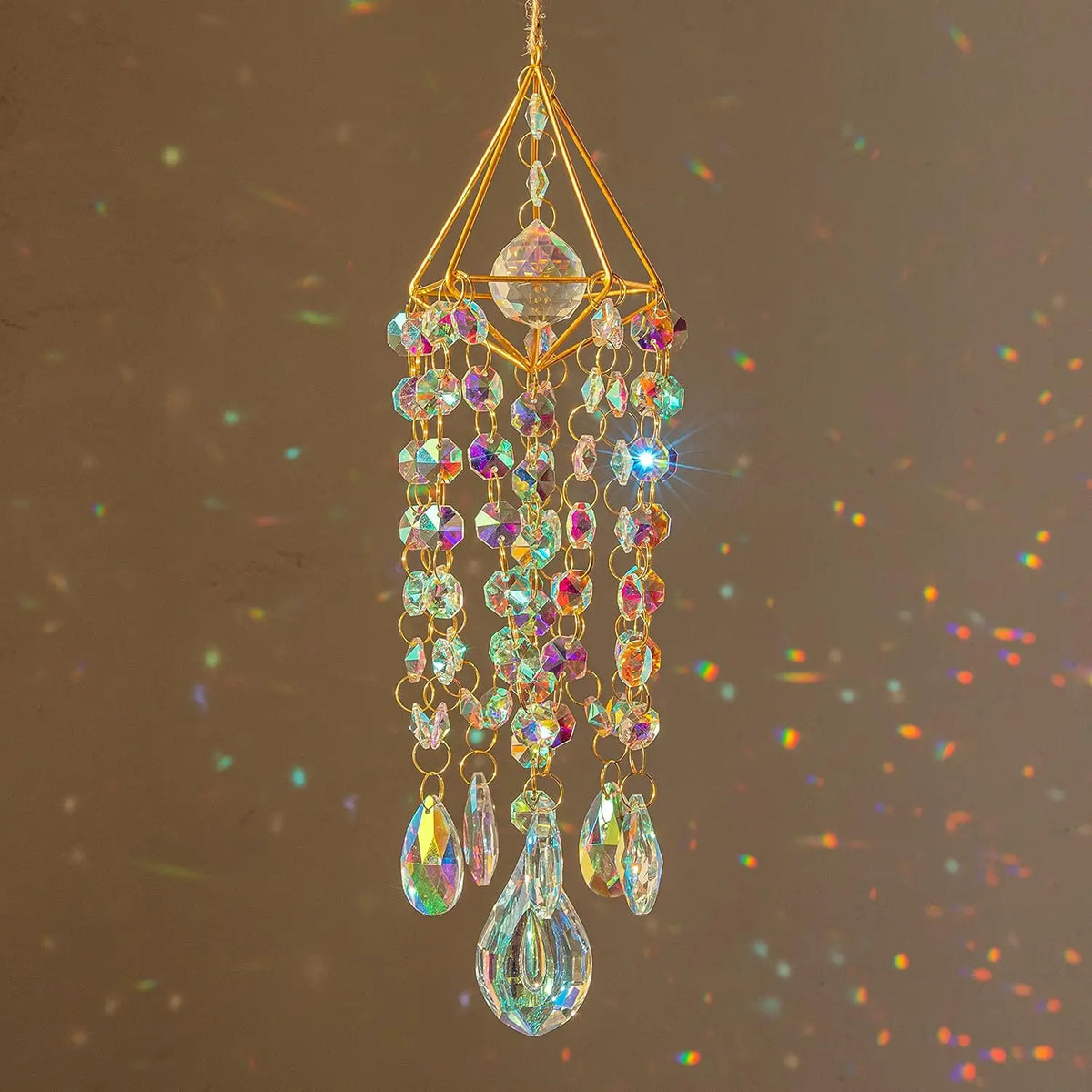 A hanging crystal rainbow wind chime featuring a central faceted stone and multiple dangling glass beads.