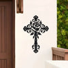 Black metal rose cross wall decor mounted on a white exterior wall.