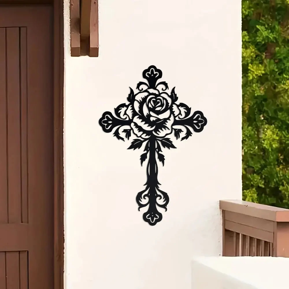 Black metal rose cross wall decor mounted on a white exterior wall.