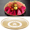 A glass plate filled with colorful sliced watermelon and tomato fruit served on a gold-rimmed platter.