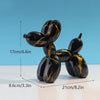 Black and gold resin balloon dog sculpture with dimensions 17cm long and 8.6cm high.