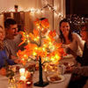 Scène intérieure festive avec une table décorée de lumières LED orange ressemblant à un bouleau.