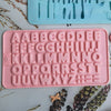 A pink silicone mold set featuring uppercase letters and numbers for baking