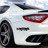 A white sports car with a black roof and a skull skeleton decal on the side, viewed from the front.