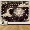 A dark tapestry wall hanging featuring a celestial design with a crescent moon, sun, and stars surrounded by cosmic elements.