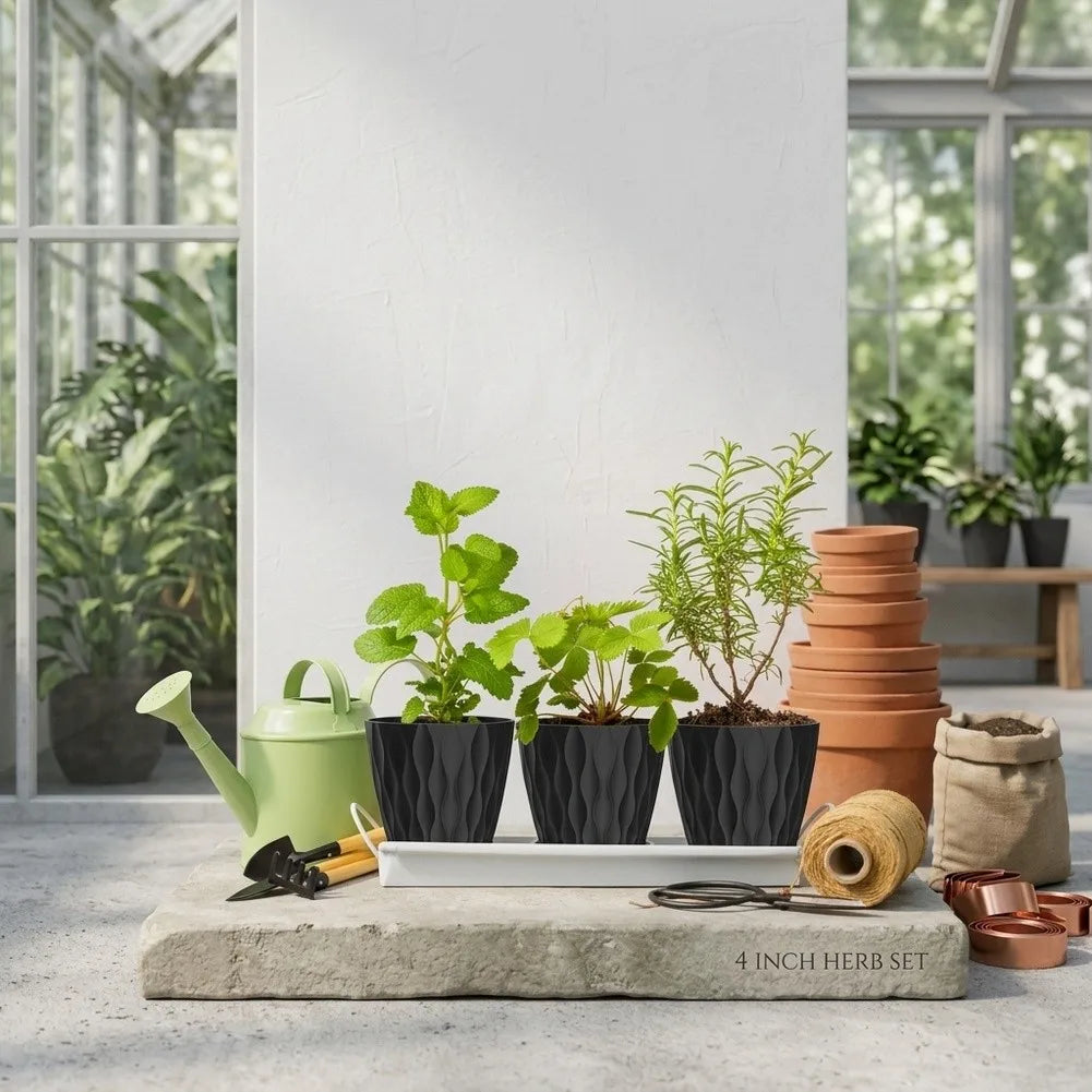 A set of six round black plastic plant pots with drainage saucers displayed on a stone slab.