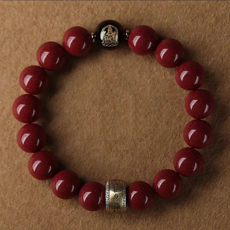 A bracelet made of polished red cinnabar stones with a dark metal clasp.