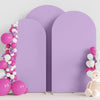 A purple spandex fitted arch backdrop decorated with pink and white balloons.