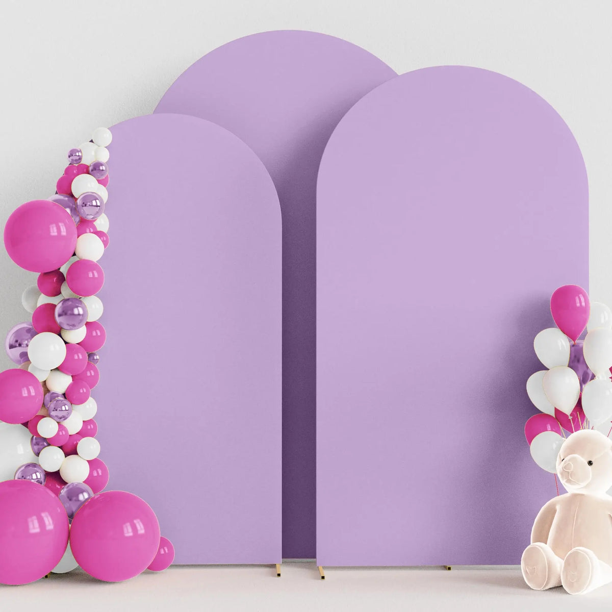 A purple spandex fitted arch backdrop decorated with pink and white balloons.