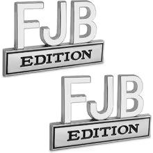 Silver metal emblem with the text FJB EDITION on a rectangular plaque.