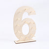 A light wood display stand shaped like the number six, used for holding desserts.