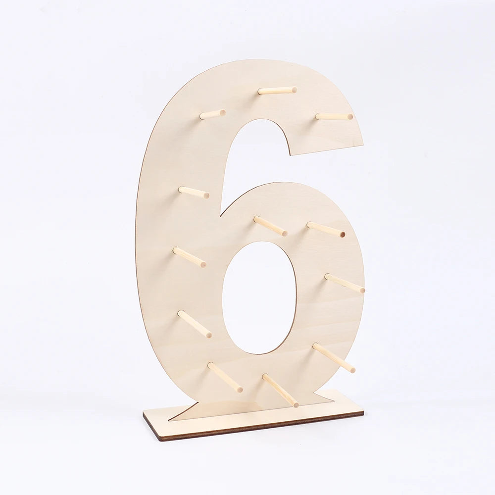 A light wood display stand shaped like the number six, used for holding desserts.