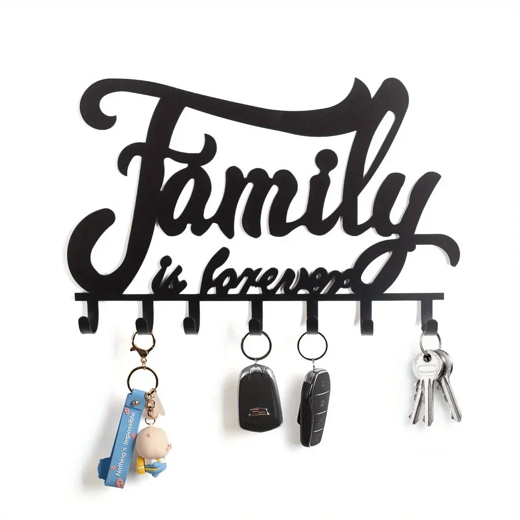 Black decorative metal wall-mounted key holder with seven hooks hanging against a white background