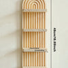 A vertical wooden wall shelf with a curved top and multiple horizontal slats for display.