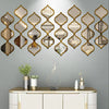 A decorative wall featuring a row of gold-framed, diamond-shaped acrylic mirrors above a white cabinet.