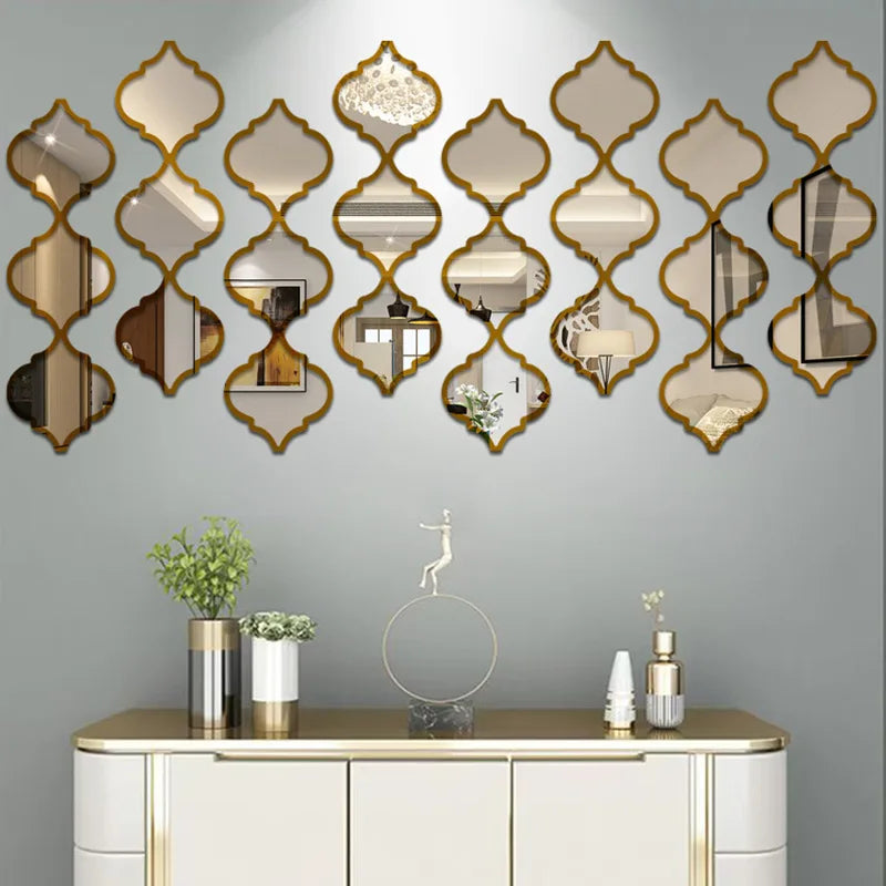 A decorative wall featuring a row of gold-framed, diamond-shaped acrylic mirrors above a white cabinet.