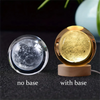 A comparison of a 3D crystal ball night light, shown without a base and with a wooden base.