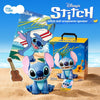Stitch doll ornaments and a speaker box displayed on sand with a guitar.