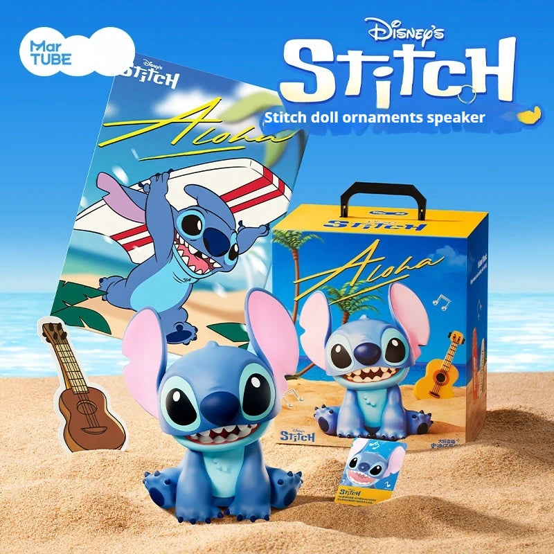Stitch doll ornaments and a speaker box displayed on sand with a guitar.