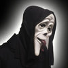 A close-up of a white horror mask with a black hood and a red tongue sticking out.