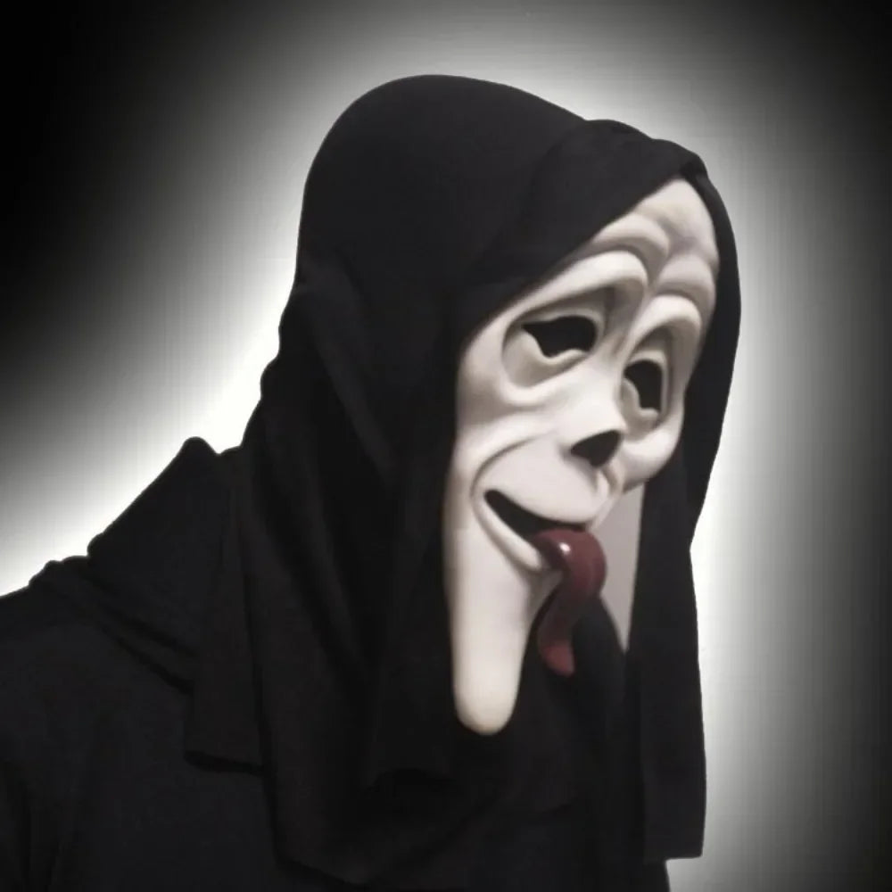 A close-up of a white horror mask with a black hood and a red tongue sticking out.