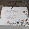 A white leather-bound guest book with elegant script text and floral watercolor design.