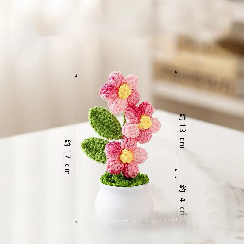 Hand woven crochet pink and yellow flowers in a white pot