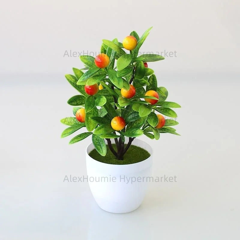 Artificial lemon tree bonsai with green leaves and yellow-orange fruit planted in a white pot