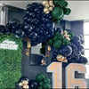 A dark background features a balloon garland with black, gold, and green balloons, decorated for a birthday.