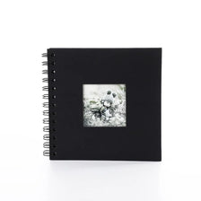 Black spiral-bound photo album with a window cover displaying a snowy landscape.