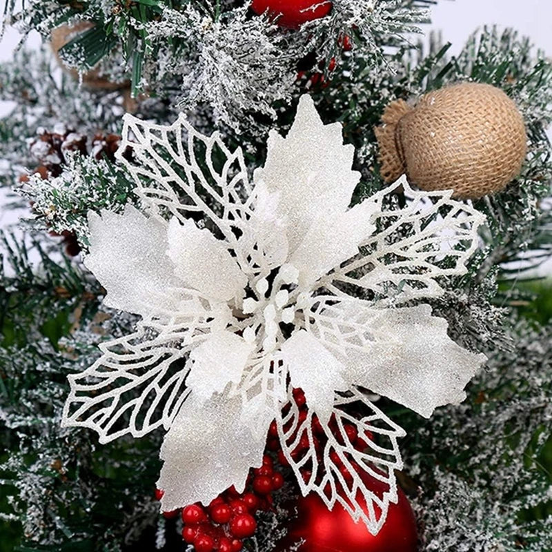 White glittery snowflake ornament on a green Christmas tree branch