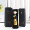 A black gift box set featuring a metallic foil rose flower, card, and display box.