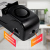 A black dual door stop security alarm set with sensitivity adjustment and on/off switch.