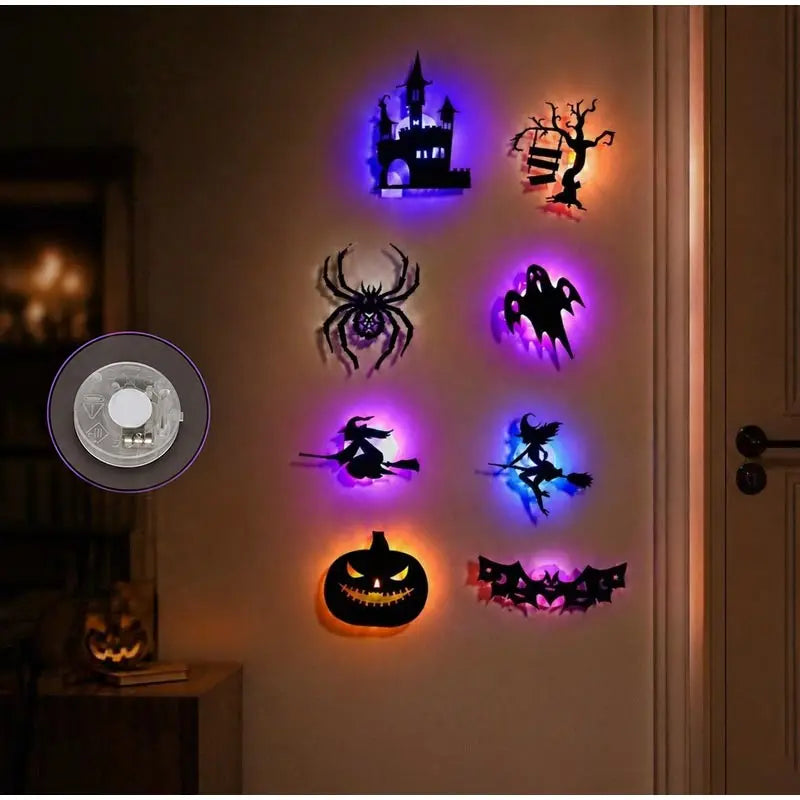 A display of Halloween themed 3D wall stickers featuring a castle, spider, bats, and a jack-o'-lantern, illuminated by purple