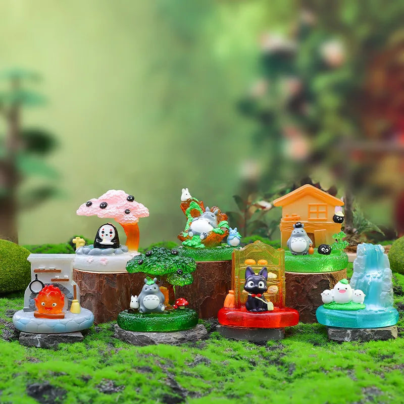 A collection of small, colorful fairy tale animal figurines and a lamp ornament displayed on mossy terrain.