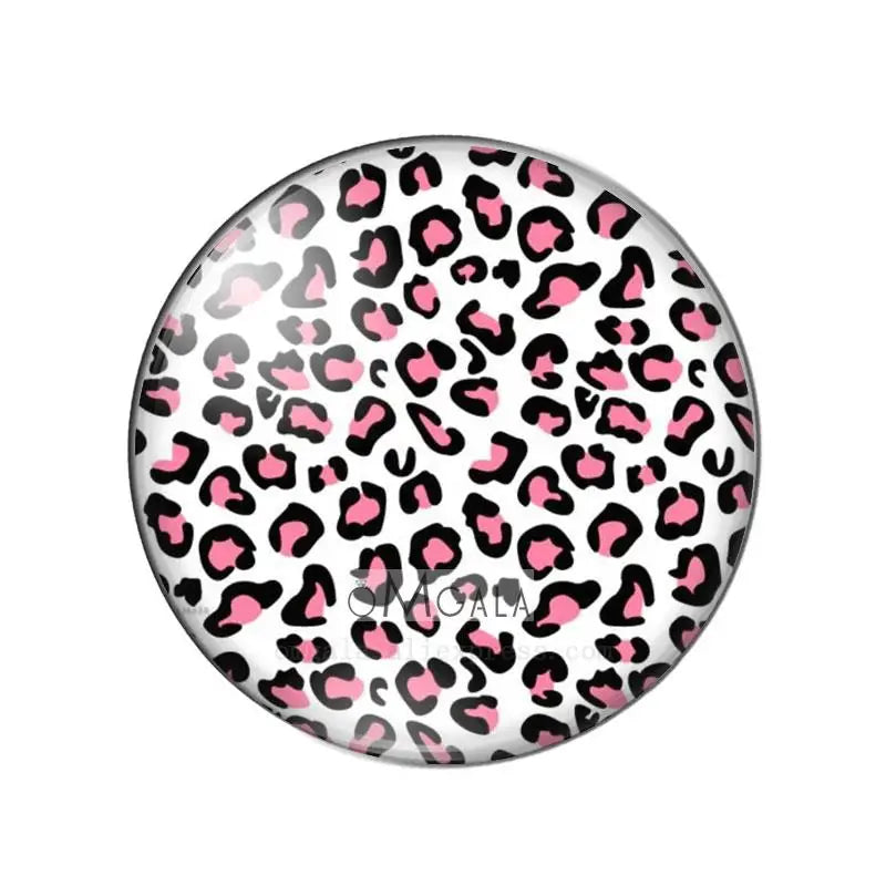 Round glass cabochon with a leopard print pattern in black and pink.