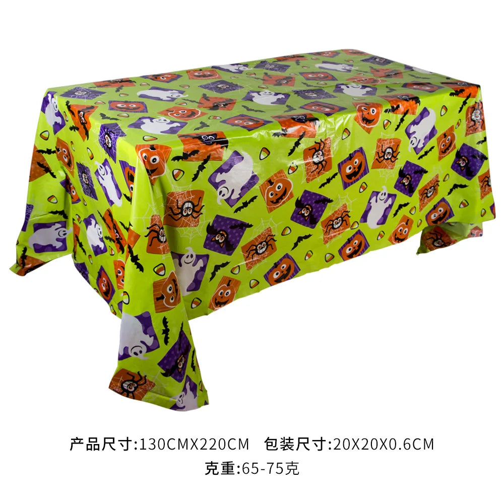 Green Halloween tablecloth featuring a pattern of pumpkins, spider webs, and bats.