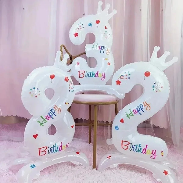 White foil balloon decoration shaped like the number 3 with a crown and birthday text