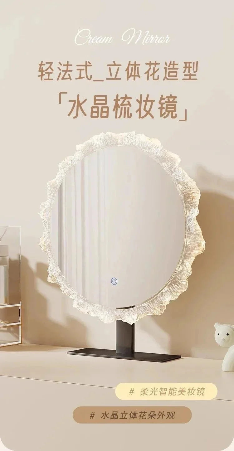 A round cream mirror with a ruffled edge and a black base, displayed on a light surface.