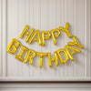 A gold foil balloon set spelling out Happy Birthday in individual letter balloons against a light background.