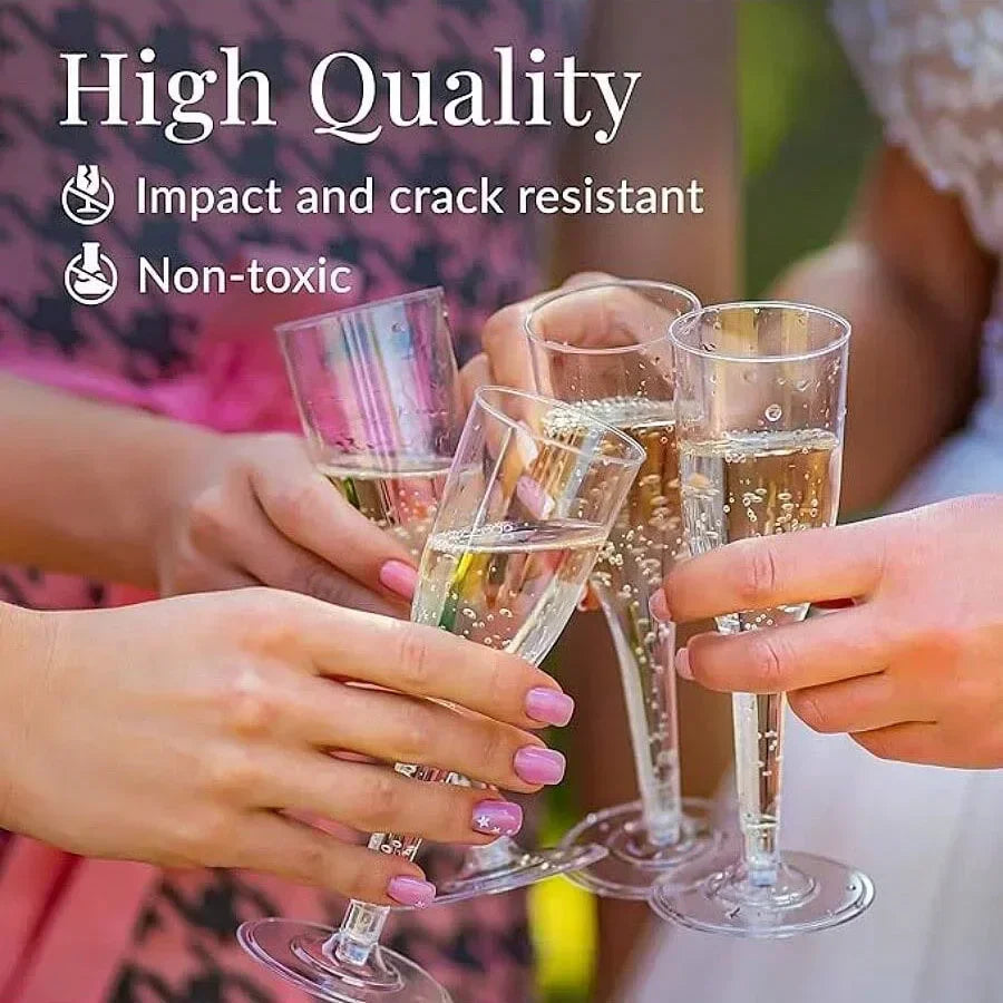 Two hands hold clear champagne glasses with a gold finish against a blurred background.